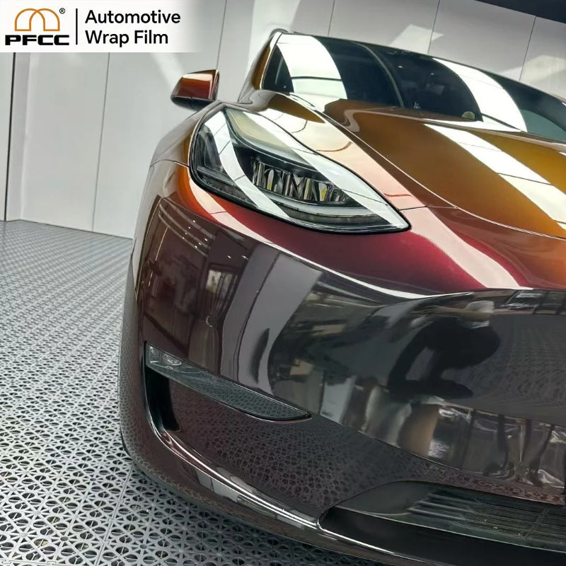 Close-up of TPU color flip film showing red reflection on black surface