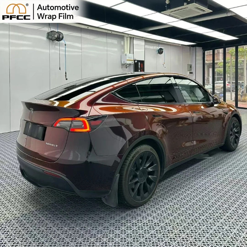 Sports car wrapped with black red gloss flip TPU wrap under sunlight