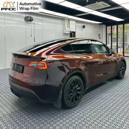 Sports car wrapped with black red gloss flip TPU wrap under sunlight